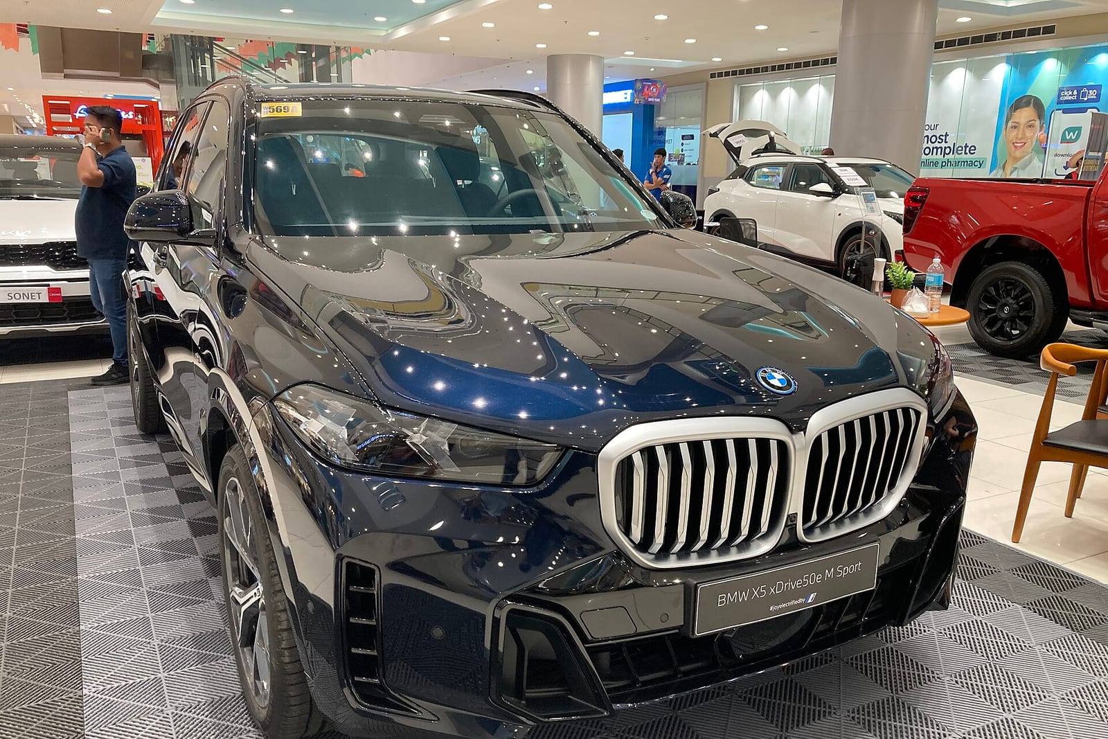 BMW iX5 at a fast-charging station