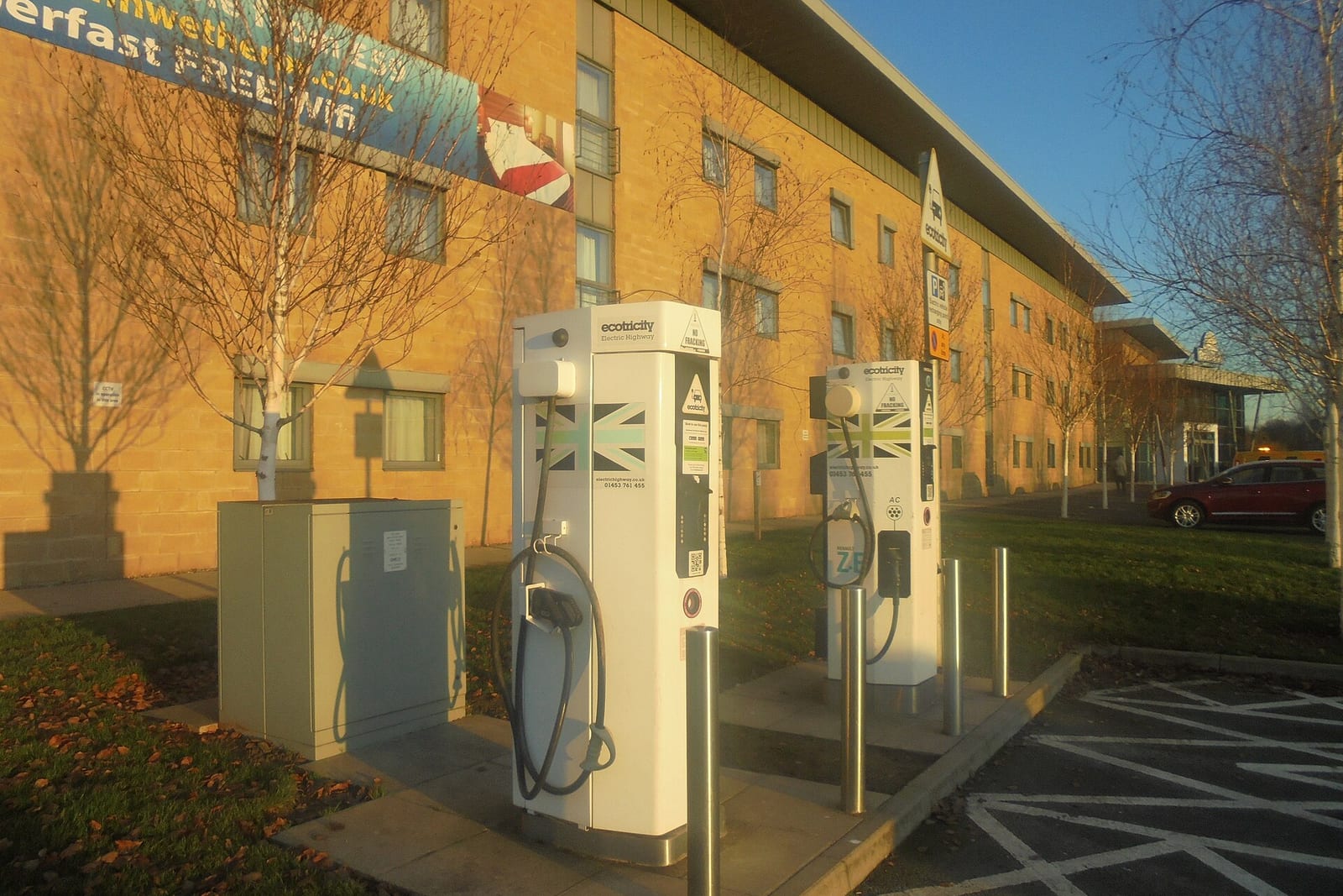 Electric vans from a fleet charging at a public charging hub